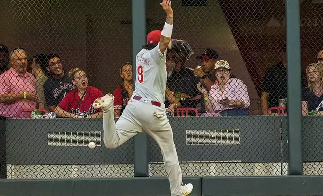 in the xx inning of a baseball game, Thursday, Aug. 22, 2024, in Atlanta. (AP Photo/Mike Stewart)