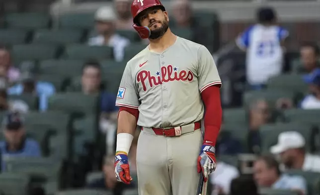 Philadelphia Phillies designated hitter Kyle Schwarber (12) reacts to a pitch in the third inning of a baseball game against the Atlanta Braves, Thursday, Aug. 22, 2024, in Atlanta. (AP Photo/Mike Stewart)