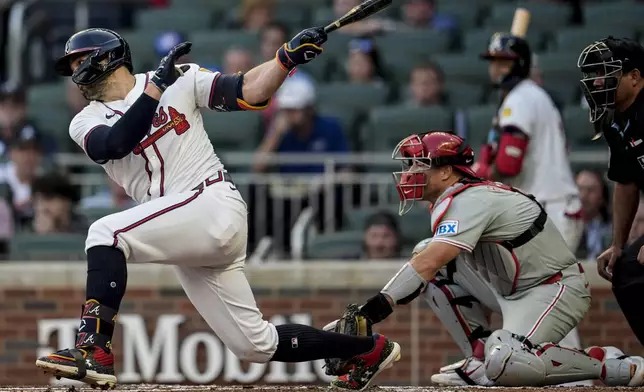 Atlanta Braves outfielder Adam Duvall (14) hits a single in the second inning in the of a baseball game against the Philadelphia Phillies, Thursday, Aug. 22, 2024, in Atlanta. (AP Photo/Mike Stewart)