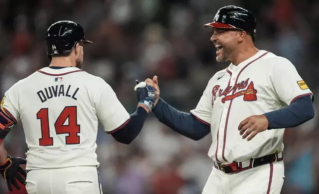 Atlanta Braves outfielder Adam Duvall (14) celebrates after hitting a solo homer against the Philadelphia Phillies in the sixth inning of a baseball game, Thursday, Aug. 22, 2024, in Atlanta. (AP Photo/Mike Stewart)