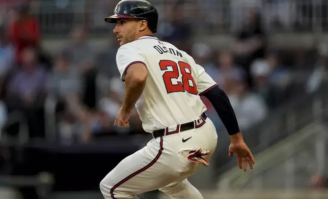 Atlanta Braves first baseman Matt Olson (28) gets caught between third base and home in the third inning of a baseball game against the Philadelphia Phillies, Thursday, Aug. 22, 2024, in Atlanta. (AP Photo/Mike Stewart)