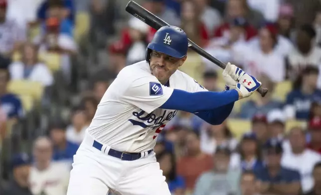 Los Angeles Dodgers' Freddie Freeman bats during the first inning of a baseball game against the Philadelphia Phillies in Los Angeles, Monday, Aug. 5, 2024. Freeman has missed last eight games as his youngest son Maximus was diagnosed with Guillan-Barre syndrome. (AP Photo/Kyusung Gong)