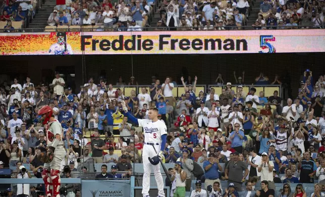 Los Angeles Dodgers' Freddie Freeman waves to the stands during the first inning of a baseball game against the Philadelphia Phillies in Los Angeles, Monday, Aug. 5, 2024. Freeman has missed last eight games as his youngest son Maximus was diagnosed with Guillan-Barre syndrome. (AP Photo/Kyusung Gong)