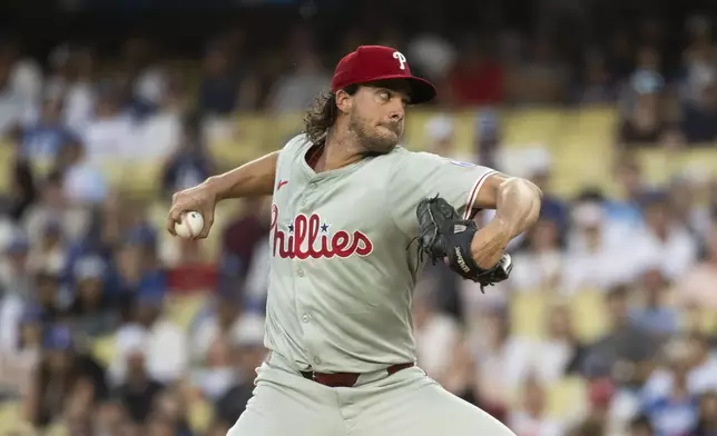 Philadelphia Phillies pitcher Aaron Nola (27) delivers a pitch during the first inning of a baseball game against the Los Angeles Dodgers in Los Angeles, Monday, Aug. 5, 2024. (AP Photo/Kyusung Gong)