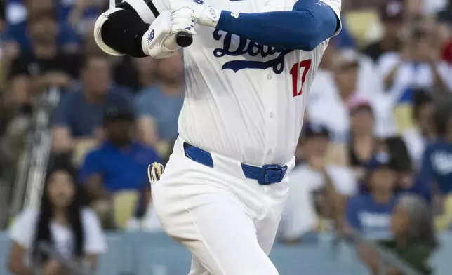 Los Angeles Dodgers' Shohei Ohtani bats during the first inning of a baseball game against the Philadelphia Phillies in Los Angeles, Tuesday, Aug. 6, 2024. (AP Photo/Kyusung Gong)