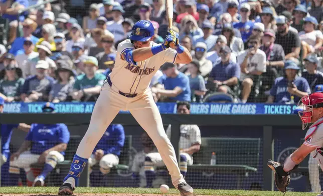 Seattle Mariners' Cal Raleigh dodges a low ball from Philadelphia Phillies pitcher Zack Wheeler during the sixth inning of a baseball game, Sunday, Aug. 4, 2024, in Seattle. (AP Photo/Liv Lyons)