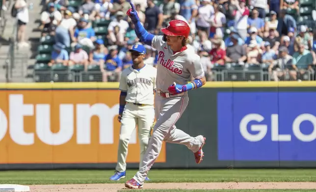 Philadelphia Phillies' Bryson Stott rounds the bases after hitting a home run during the eighth inning of a baseball game against the Seattle Mariners, Sunday, Aug. 4, 2024, in Seattle. (AP Photo/Liv Lyons)