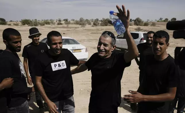 Qaid Farhan Alkadi, who was held hostage by Hamas militants in Gaza Strip, meets his relatives and friends after arriving in the Khirbet Karkur village, near Rahat, southern Israel, Aug. 28, 2024. (AP Photo/Mahmoud Illean)