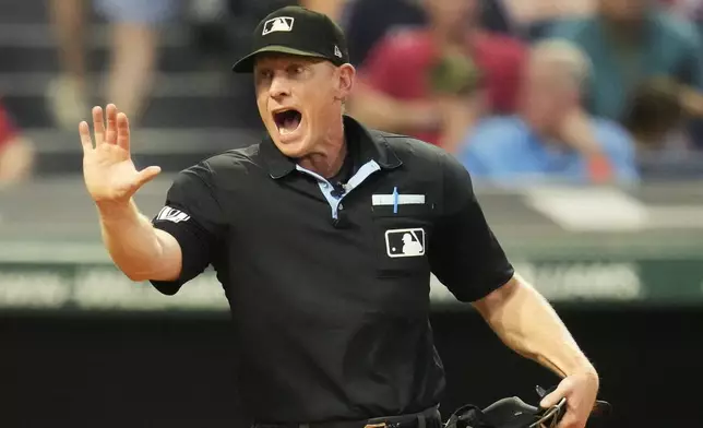 Home plate umpire Brian Walsh shouts at Pirates manager Derek Shelton in the fourth inning of a baseball game against the Cleveland Guardians Friday, Aug. 30, 2024, in Cleveland. (AP Photo/Sue Ogrocki)