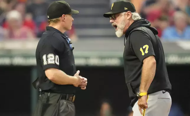 Pittsburgh Pirates manager Derek Shelton, right, argues with home plate umpire Brian Walsh, left, after being ejected in the fourth inning of a baseball game against the Cleveland Guardians Friday, Aug. 30, 2024, in Cleveland. (AP Photo/Sue Ogrocki)