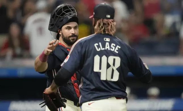 Cleveland Guardians catcher Austin Hedges, left, congratulates relief pitcher Emmanuel Clase (48) after they defeated the Pittsburgh Pirates in a baseball game Friday, Aug. 30, 2024, in Cleveland. (AP Photo/Sue Ogrocki)