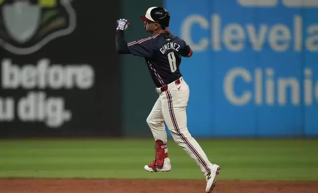 Cleveland Guardians' Andres Gimenez celebrates as he runs the bases after hitting a home run in the fifth inning of a baseball game against the Pittsburgh Pirates, Friday, Aug. 30, 2024, in Cleveland. (AP Photo/Sue Ogrocki)