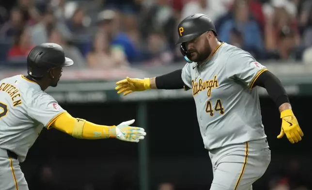 Pittsburgh Pirates' Rowdy Tellez (44) is congratulated by teammate Andrew McCutchen, left, after hitting a home run in the fifth inning of a baseball game against the Cleveland Guardians, Friday, Aug. 30, 2024, in Cleveland. (AP Photo/Sue Ogrocki)