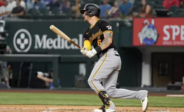 Pittsburgh Pirates' Yasmani Grandal follows through on a double play swing that left Jared Triolo out at second in the second inning of a baseball game against the Texas Rangers, Wednesday, Aug. 21, 2024, in Arlington, Texas. (AP Photo/Tony Gutierrez)