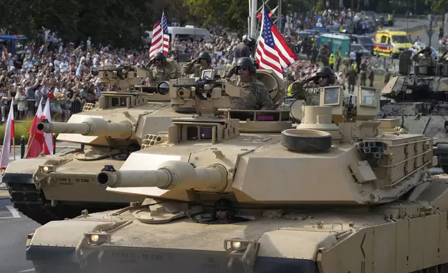 U.S. troops from NATO member Poland and some of its allies showcase military equipment during the yearly observances on Poland's armed forces holiday in Warsaw, Poland, on Thursday, Aug. 15, 2024. (AP Photo/Czarek Sokolowski)