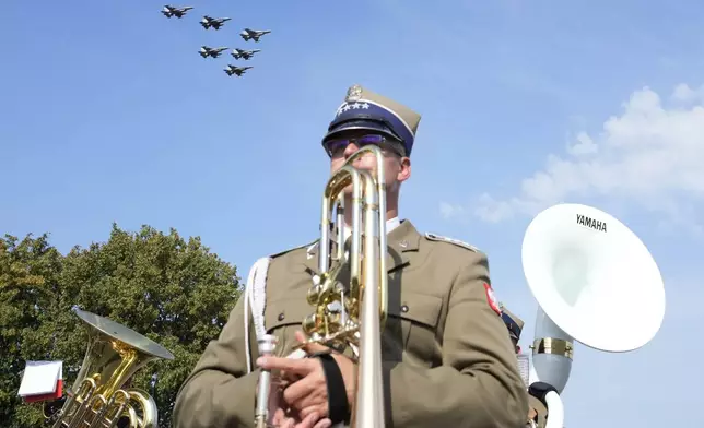 A military band plays during the annual observances on Poland's armed forces day, in Warsaw, Poland, on Thursday, Aug. 15, 2024. (AP Photo/Czarek Sokolowski)