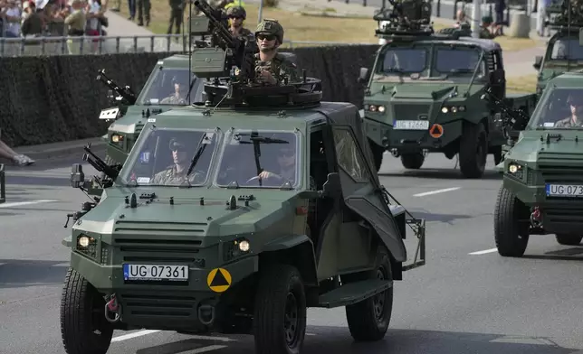 Poland military cars parade during the annual observances on Poland's armed forces holiday in Warsaw, Poland, on Thursday, Aug. 15, 2024. (AP Photo/Czarek Sokolowski)