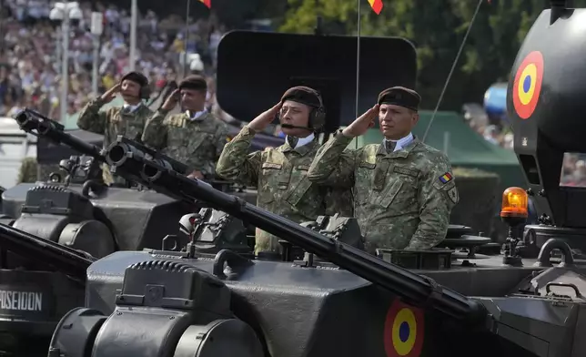 Romania troops from NATO member Poland and some of its allies showcase military equipment during the yearly observances on Poland's armed forces holiday in Warsaw, Poland, on Thursday, Aug. 15, 2024. (AP Photo/Czarek Sokolowski)