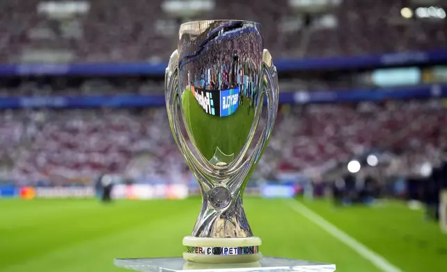 The trophy is displayed on the pitch ahead of the UEFA Super Cup Final soccer match between Real Madrid and Atalanta at the Narodowy stadium in Warsaw, Poland, Wednesday, Aug. 14, 2024. (AP Photo/Darko Bandic)