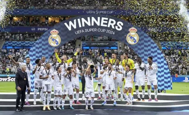 Real Madrid's Luka Modric lifts the trophy after winning the UEFA Super Cup Final soccer match between Real Madrid and Atalanta at the Narodowy stadium in Warsaw, Poland, Wednesday, Aug. 14, 2024. Real Madrid won 2-0. (AP Photo/Darko Bandic)