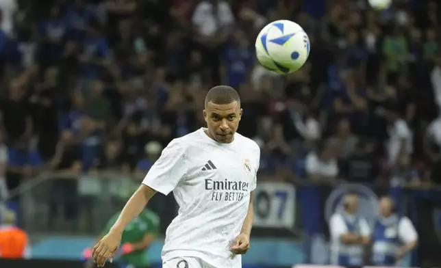 Real Madrid's Kylian Mbappe warms up before the UEFA Super Cup Final soccer match between Real Madrid and Atalanta at the Narodowy stadium in Warsaw, Poland, Wednesday, Aug. 14, 2024. (AP Photo/Czarek Sokolowski)