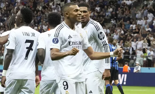 Real Madrid's Kylian Mbappe, second from right, celebrates after scoring his side's second goal during the UEFA Super Cup Final soccer match between Real Madrid and Atalanta at the Narodowy stadium in Warsaw, Poland, Wednesday, Aug. 14, 2024. (AP Photo/Czarek Sokolowski)