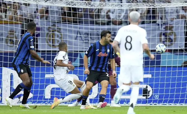 Real Madrid's Kylian Mbappe, 2nd left, scores his side's second goal during the UEFA Super Cup Final soccer match between Real Madrid and Atalanta at the Narodowy stadium in Warsaw, Poland, Wednesday, Aug. 14, 2024. (AP Photo/Darko Bandic)