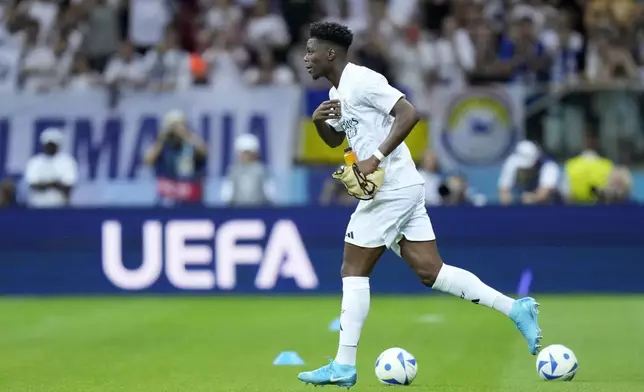 Real Madrid's Aurelien Tchouameni walks on to the pitch for warmup before the UEFA Super Cup Final soccer match between Real Madrid and Atalanta at the Narodowy stadium in Warsaw, Poland, Wednesday, Aug. 14, 2024. (AP Photo/Darko Bandic)