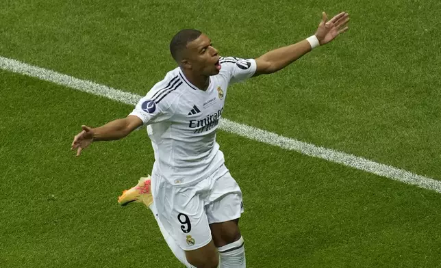 Real Madrid's Kylian Mbappe celebrates after scoring his side's second goal during the UEFA Super Cup Final soccer match between Real Madrid and Atalanta at the Narodowy stadium in Warsaw, Poland, Wednesday, Aug. 14, 2024. (AP Photo/Darko Vojinovic)