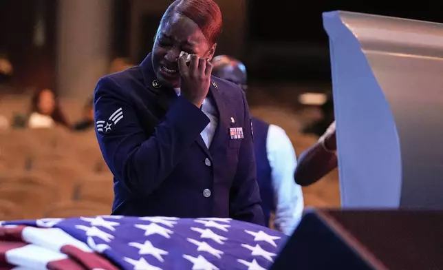 FILE - U.S. Air Force personnel stand near the coffin of slain airman Roger Fortson during his funeral at New Birth Missionary Baptist Church, Friday, May 17, 2024, near Atlanta. (AP Photo/Brynn Anderson, File)