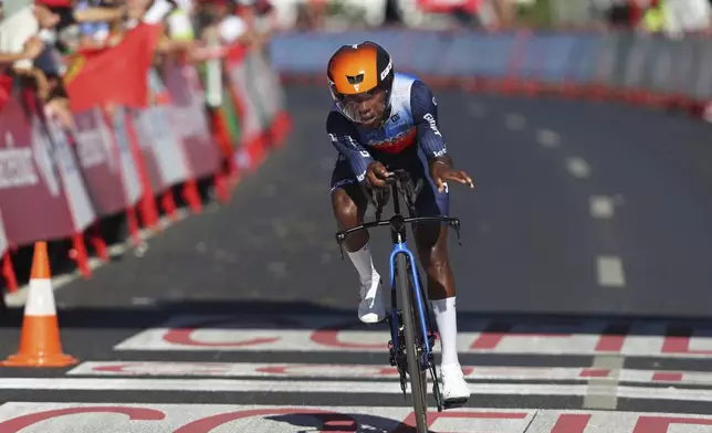 Welay Hagos Berhe, of Ethiopia, crosses the finish line in the first stage of the tour of Spain, La Vuelta, cycling race, an individual time trial with start in Lisbon and finish in Oeiras, Portugal, Saturday, Aug. 17, 2024. (AP Photo/Pedro Rocha)