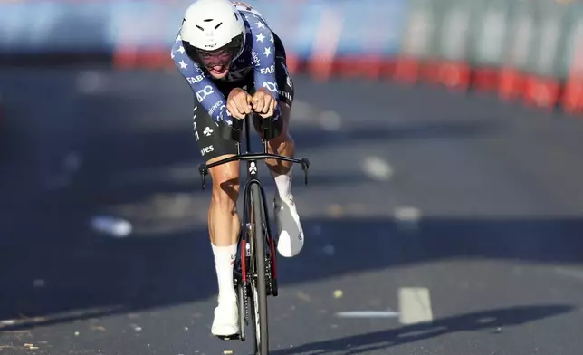 Brandon McNulty, of the United States, approaches the finish line to win the first stage of the tour of Spain, La Vuelta, cycling race, an individual time trial with start in Lisbon and finish in Oeiras, Portugal, Saturday, Aug. 17, 2024. (AP Photo/Pedro Rocha)