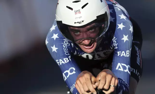 Brandon McNulty, of the United States, crosses the finish line to win the first stage of the tour of Spain, La Vuelta, cycling race, an individual time trial with start in Lisbon and finish in Oeiras, Portugal, Saturday, Aug. 17, 2024. (AP Photo/Pedro Rocha)