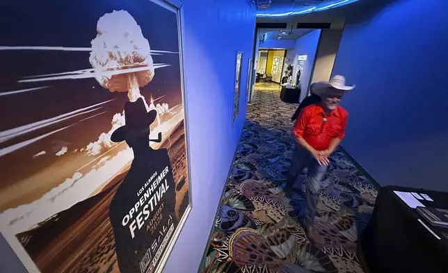 Downwinder Paul Pino heads through the SALA Event Center toward the screening of "First We Bombed New Mexico" during the Oppenheimer Film Festival in Los Alamos, New Mexico on Saturday, Aug. 17, 2024. The documentary tells the stories of those who lived near the Trinity Test Site when the U.S. government detonated the first atomic bomb and the Native Americans who worked in the uranium industry. (AP Photo/Susan Montoya Bryan)