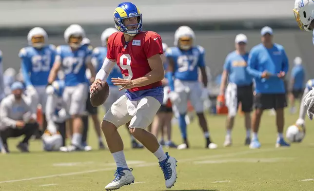 Los Angeles Rams quarterback Matthew Stafford (9) looks to pass the ball during NFL football practice at The Bolt in El Segundo, Calif., Sunday, Aug. 4, 2024. The Rams and the Chargers are having joint practices. (AP Photo/Damian Dovarganes)