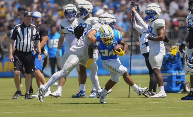 Los Angeles Chargers running back Jaret Patterson (34) runs with the ball during NFL football practice at The Bolt in El Segundo, Calif., Sunday, Aug. 4, 2024. The Rams and the Chargers are having joint practices. (AP Photo/Damian Dovarganes)