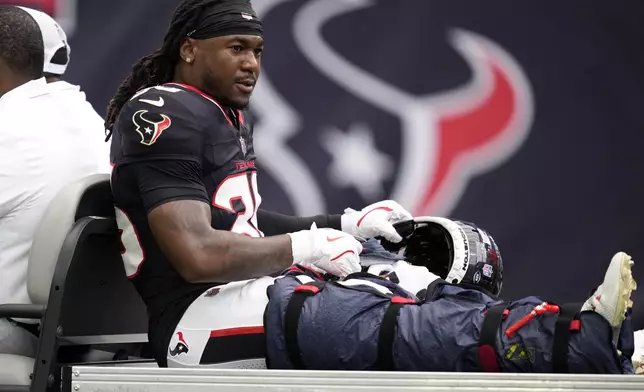 Houston Texans safety Brandon Hill (36) is carted off the field after getting injured during the first half of a preseason NFL football game against the Los Angeles Rams, Saturday, Aug. 24, 2024, in Houston. (AP Photo/Eric Christian Smith)