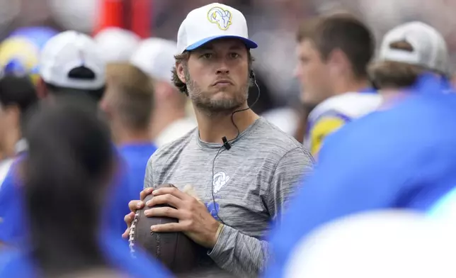 Los Angeles Rams quarterback Matthew Stafford throws on the sideline during the second half of a preseason NFL football game against the Houston Texans, Saturday, Aug. 24, 2024, in Houston. (AP Photo/Eric Gay)