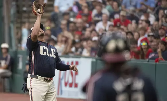 Cleveland Guardians' Josh Naylor catches a pop foul by Texas Rangers' Adolis Garcia during the first inning of a baseball game in Cleveland, Friday, Aug. 23, 2024. (AP Photo/Phil Long)