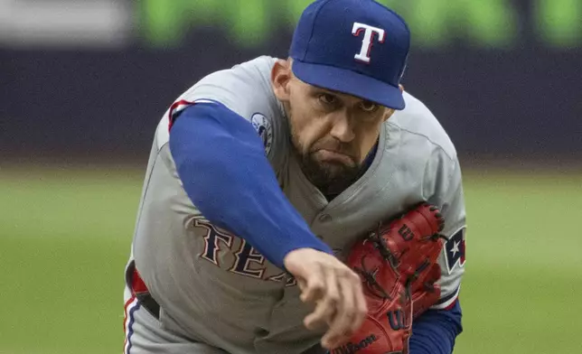 Texas Rangers starting pitcher Nathan Eovaldi delivers against the Cleveland Guardians during the first inning of a baseball game in Cleveland, Friday, Aug. 23, 2024. (AP Photo/Phil Long)