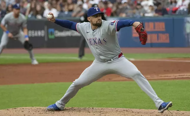 Texas Rangers starting pitcher Nathan Eovaldi delivers against the Cleveland Guardians during the first inning of a baseball game in Cleveland, Friday, Aug. 23, 2024. (AP Photo/Phil Long)