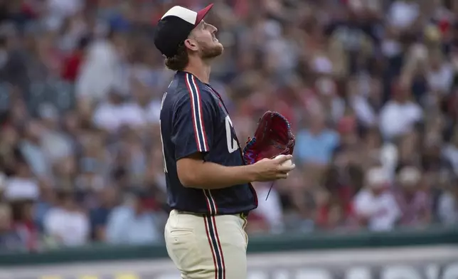 Cleveland Guardians starter Tanner Bibee pauses between pitches during the second inning of a baseball game against the Texas Rangers in Cleveland, Friday, Aug. 23, 2024. (AP Photo/Phil Long)