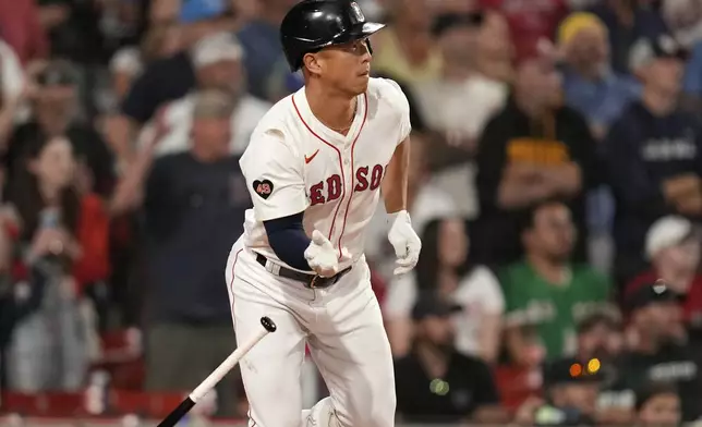 Boston Red Sox's Rob Refsnyder watches his winning RBI single in the 10th inning of a baseball game against the Texas Rangers at Fenway Park, Monday, Aug. 12, 2024, in Boston. (AP Photo/Charles Krupa)