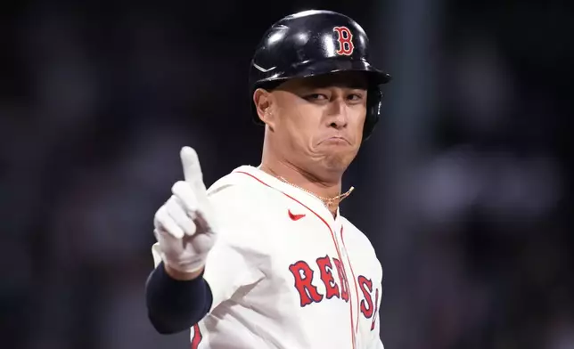 Boston Red Sox's Rob Refsnyder celebrates after his winning RBI single in the 10th inning of a baseball game against the Texas Rangers at Fenway Park, Monday, Aug. 12, 2024, in Boston. (AP Photo/Charles Krupa)