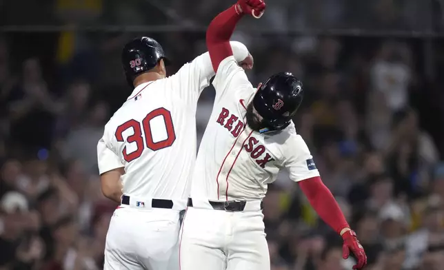 Boston Red Sox's Connor Wong, right, celebrates with Boston Red Sox outfielder Rob Refsnyder (30) after his three-run home run during the fifth inning of a baseball game against the Texas Rangers, Tuesday, Aug. 13, 2024, in Boston. (AP Photo/Charles Krupa)