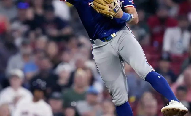 Texas Rangers third baseman Josh Jung fields a ground out by Boston Red Sox's Ceddanne Rafaela during the third inning of a baseball game, Tuesday, Aug. 13, 2024, in Boston. (AP Photo/Charles Krupa)