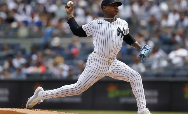 New York Yankees pitcher Marcus Stroman delivers to the plate during the first inning of a baseball game against the Texas Rangers, Sunday, Aug. 11, 2024, in New York. (AP Photo/John Munson)