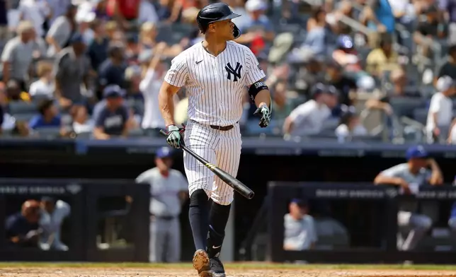 New York Yankees' Giancarlo Stanton watches his home run during the fifth inning of a baseball game against the Texas Rangers, Sunday, Aug. 11, 2024, in New York. (AP Photo/John Munson)