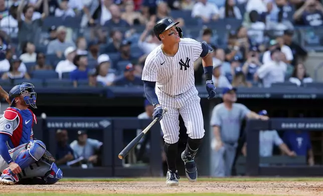 New York Yankees batter Aaron Judge hits a home run in the seventh inning during a baseball game against the Texas Rangers Sunday, Aug. 11, 2024, in New York. (AP Photo/John Munson)