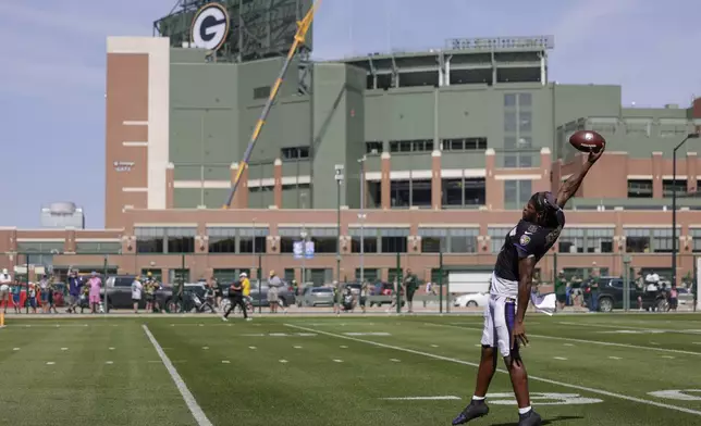 Baltimore Ravens quarterback Lamar Jackson catches a pass during an NFL football joint training camp practice with the Green Bay Packers Thursday, Aug. 22, 2024, in Green Bay, Wis. (AP Photo/Matt Ludtke)